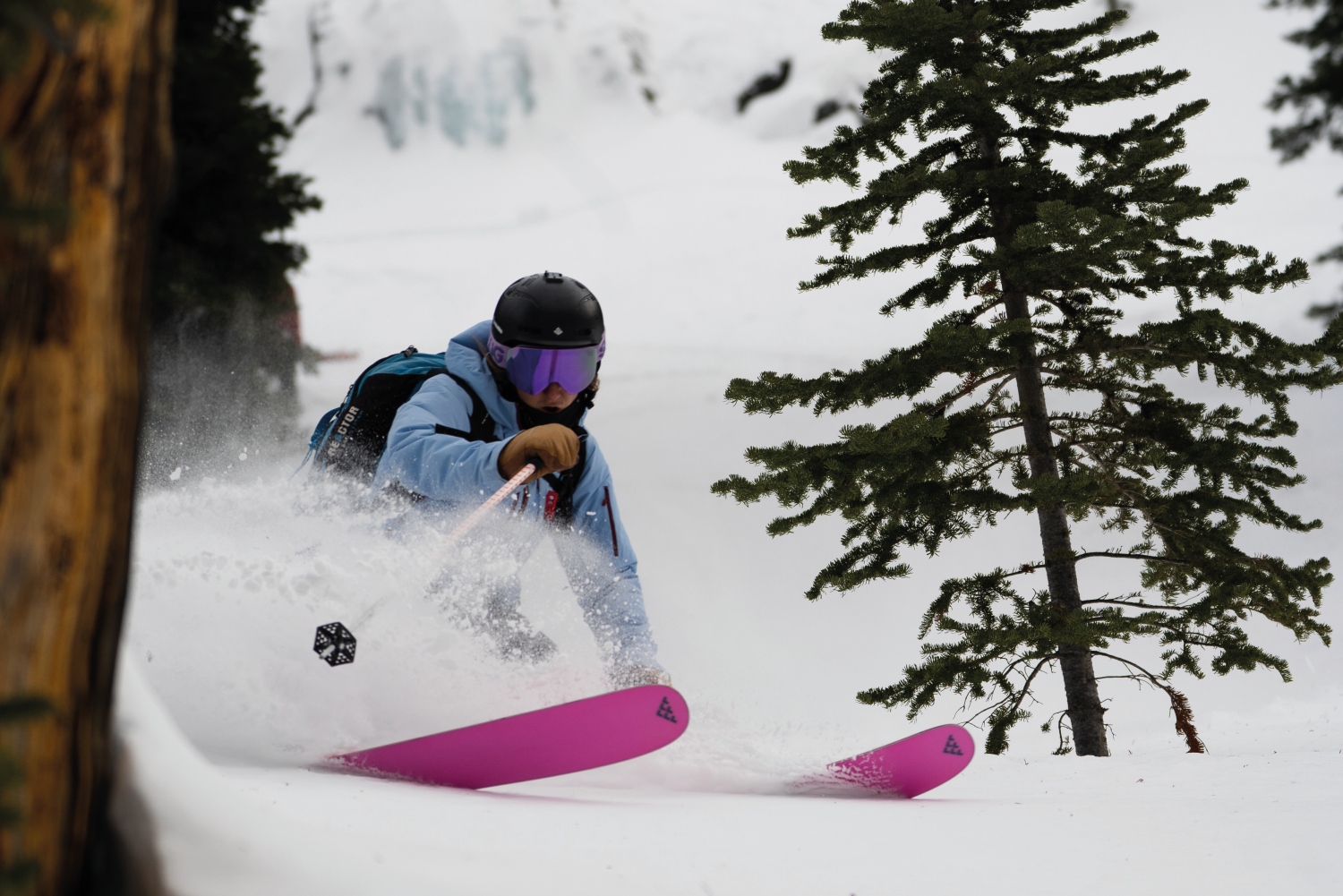 Woman skiing by trees